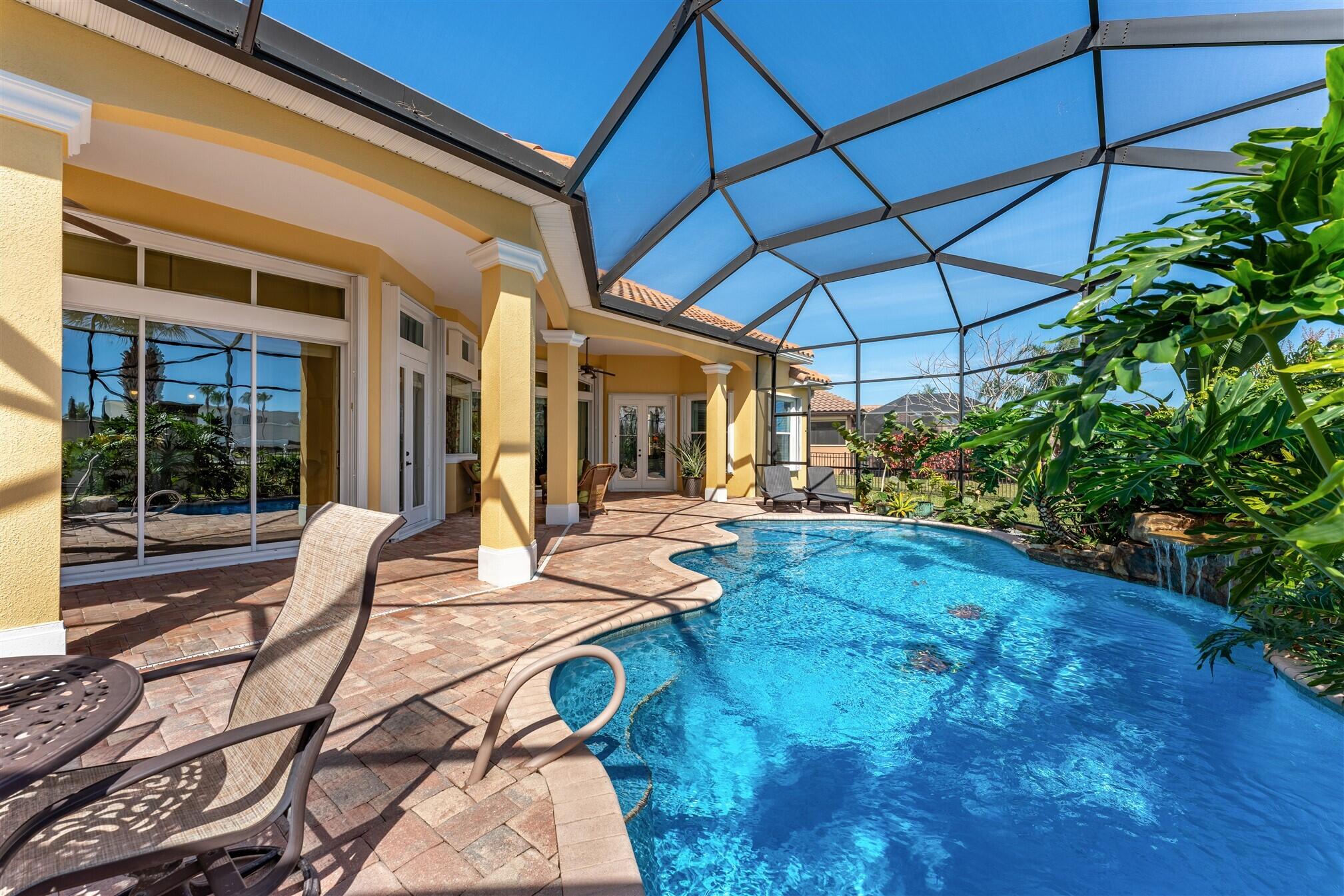 3210 Levanto Drive Melbourne, FL 32940 - Photo 50 of 76 a view of a patio with table and chairs under an umbrella