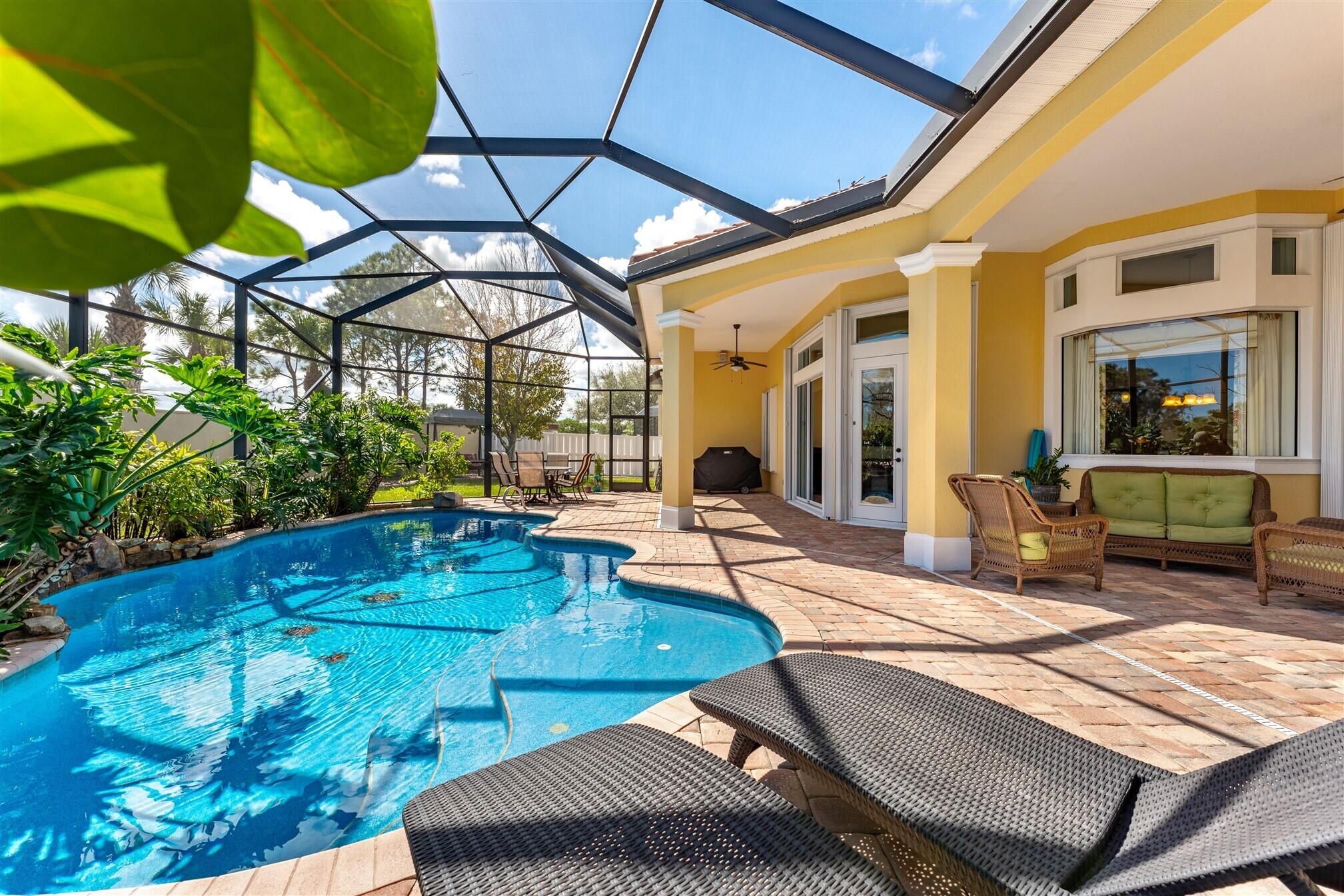 3210 Levanto Drive Melbourne, FL 32940 - Photo 53 of 76 a view of a patio with table and chairs under an umbrella