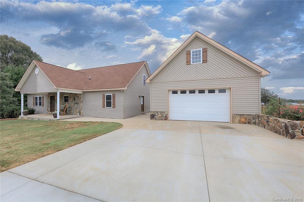 166 Stikeleather Road Stony Point, NC 28678 - Photo 2 of 48 a front view of a house with a yard and garage