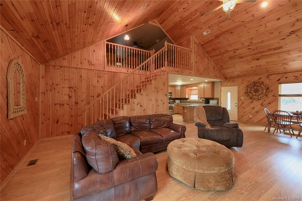 166 Stikeleather Road Stony Point, NC 28678 - Photo 15 of 48 a media room with lots of chairs and a chandelier