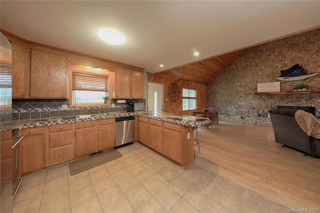166 Stikeleather Road Stony Point, NC 28678 - Photo 17 of 48 a large kitchen with granite countertop a large counter top space a sink stainless steel appliances and cabinets