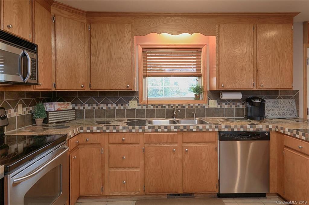 166 Stikeleather Road Stony Point, NC 28678 - Photo 20 of 48 a kitchen with stainless steel appliances granite countertop a stove a sink and a microwave
