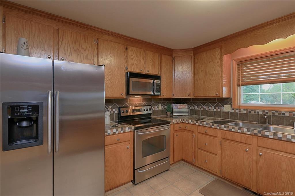 166 Stikeleather Road Stony Point, NC 28678 - Photo 21 of 48 a kitchen with a refrigerator sink and cabinets