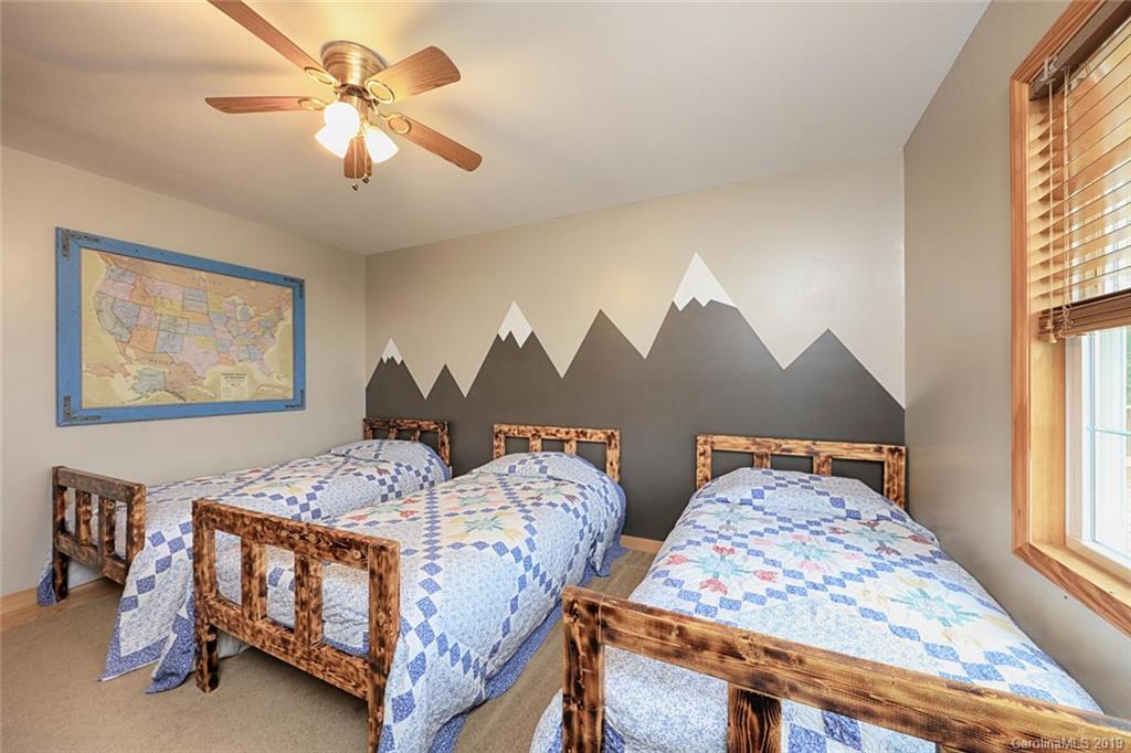 166 Stikeleather Road Stony Point, NC 28678 - Photo 28 of 48 a bedroom with two beds and a chandelier