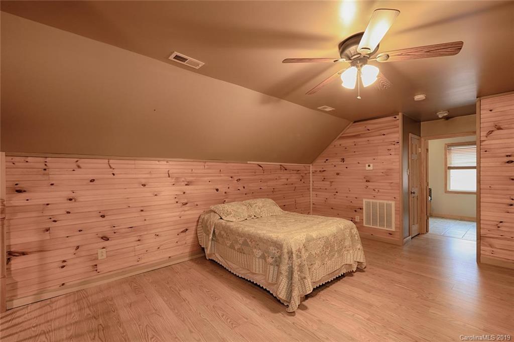 166 Stikeleather Road Stony Point, NC 28678 - Photo 30 of 48 a spacious bedroom with a bed and a ceiling fan