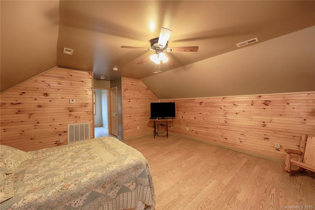 166 Stikeleather Road Stony Point, NC 28678 - Photo 31 of 48 a bedroom with a bed and a chandelier
