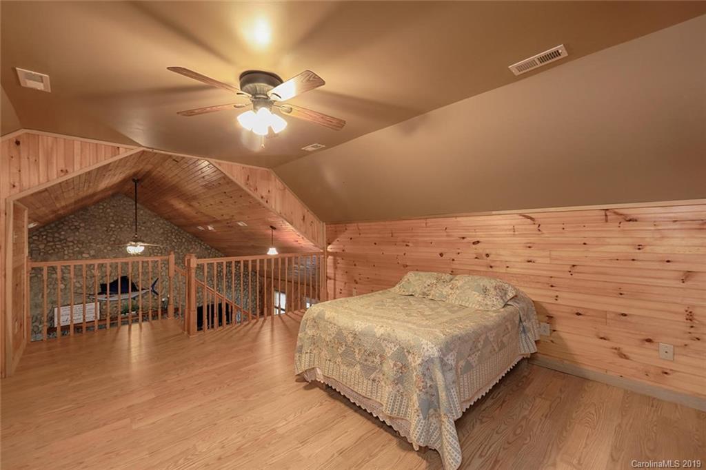 166 Stikeleather Road Stony Point, NC 28678 - Photo 32 of 48 a bedroom with a bed and a chandelier