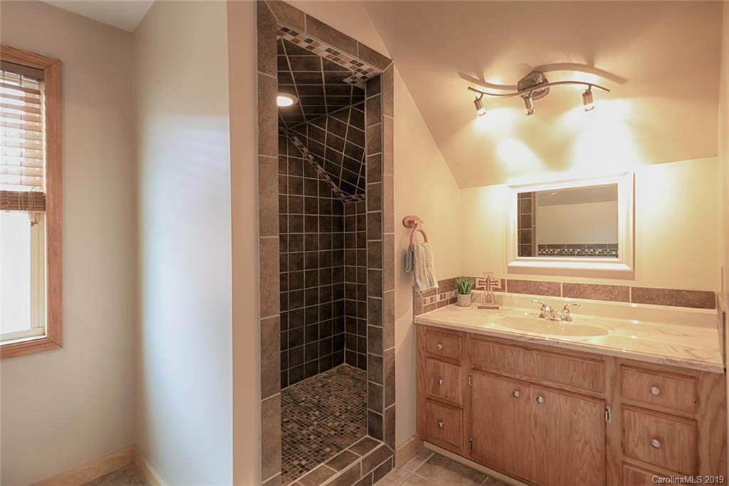 166 Stikeleather Road Stony Point, NC 28678 - Photo 33 of 48 a bathroom with a shower sink and mirror