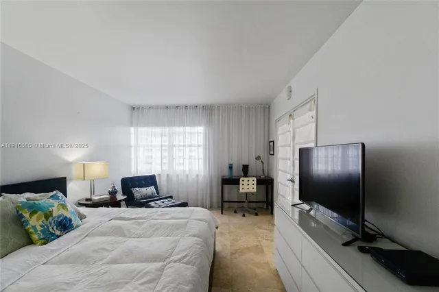 a bedroom with a bed and tv