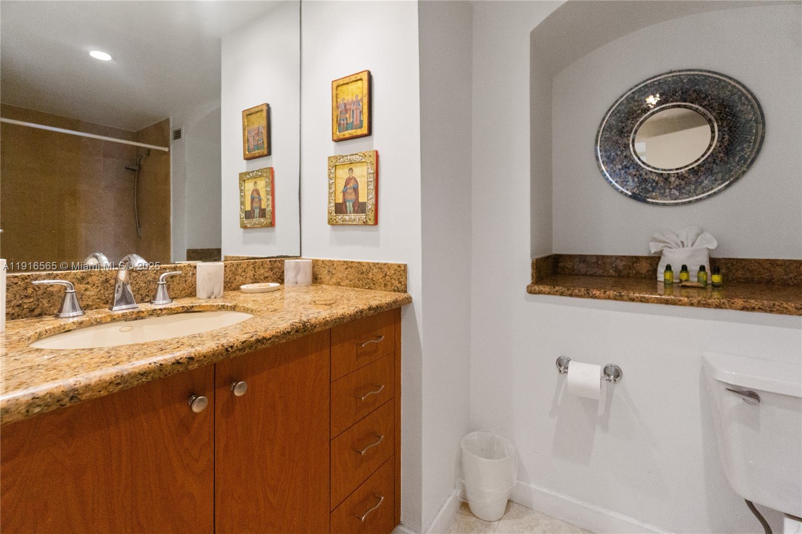 100 Lincoln Road, Unit 847 Miami Beach, FL 33139 - Photo 15 of 23 a bathroom with a granite countertop sink and a mirror
