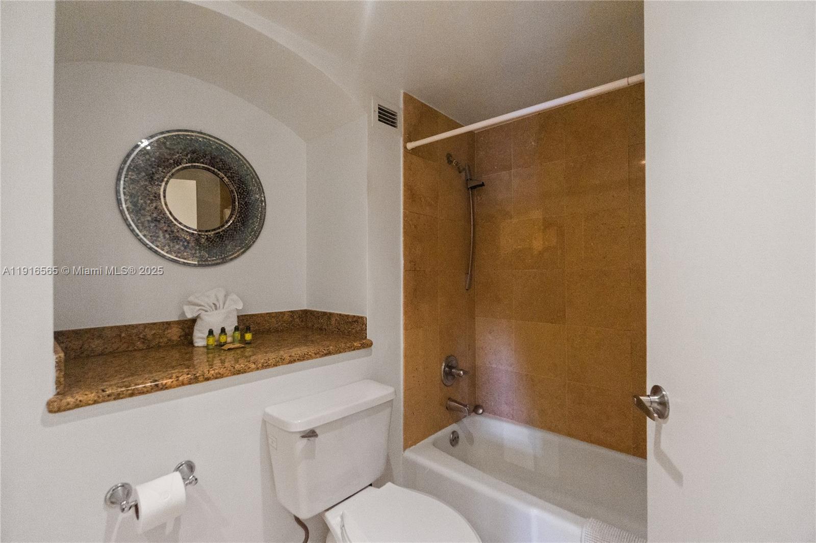 100 Lincoln Road, Unit 847 Miami Beach, FL 33139 - Photo 16 of 23 a bathroom with a granite countertop sink mirror vanity and toilet