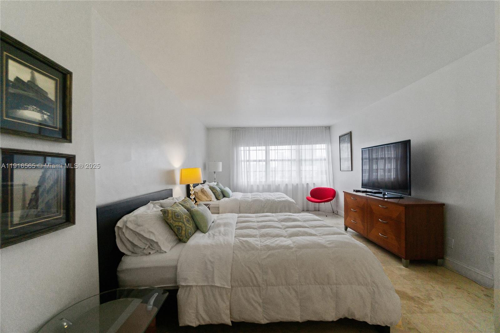 100 Lincoln Road, Unit 847 Miami Beach, FL 33139 - Photo 18 of 23 a bedroom with a bed and flat screen tv