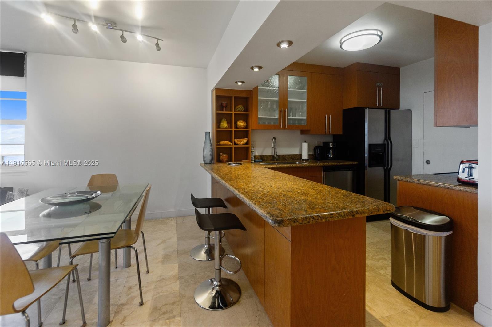 100 Lincoln Road, Unit 847 Miami Beach, FL 33139 - Photo 4 of 23 a kitchen with stainless steel appliances granite countertop sink stove top oven and cabinets