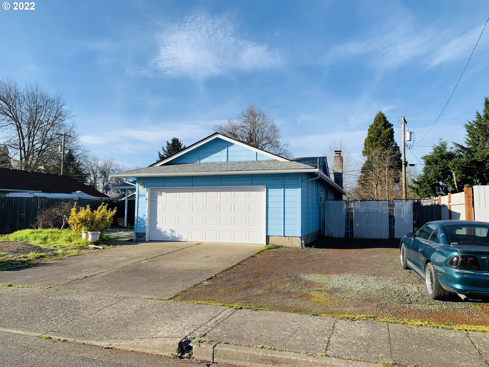 458 West Olympic Street Springfield, OR 97477 - Photo 8 of 23 a front view of a house with a yard and garage