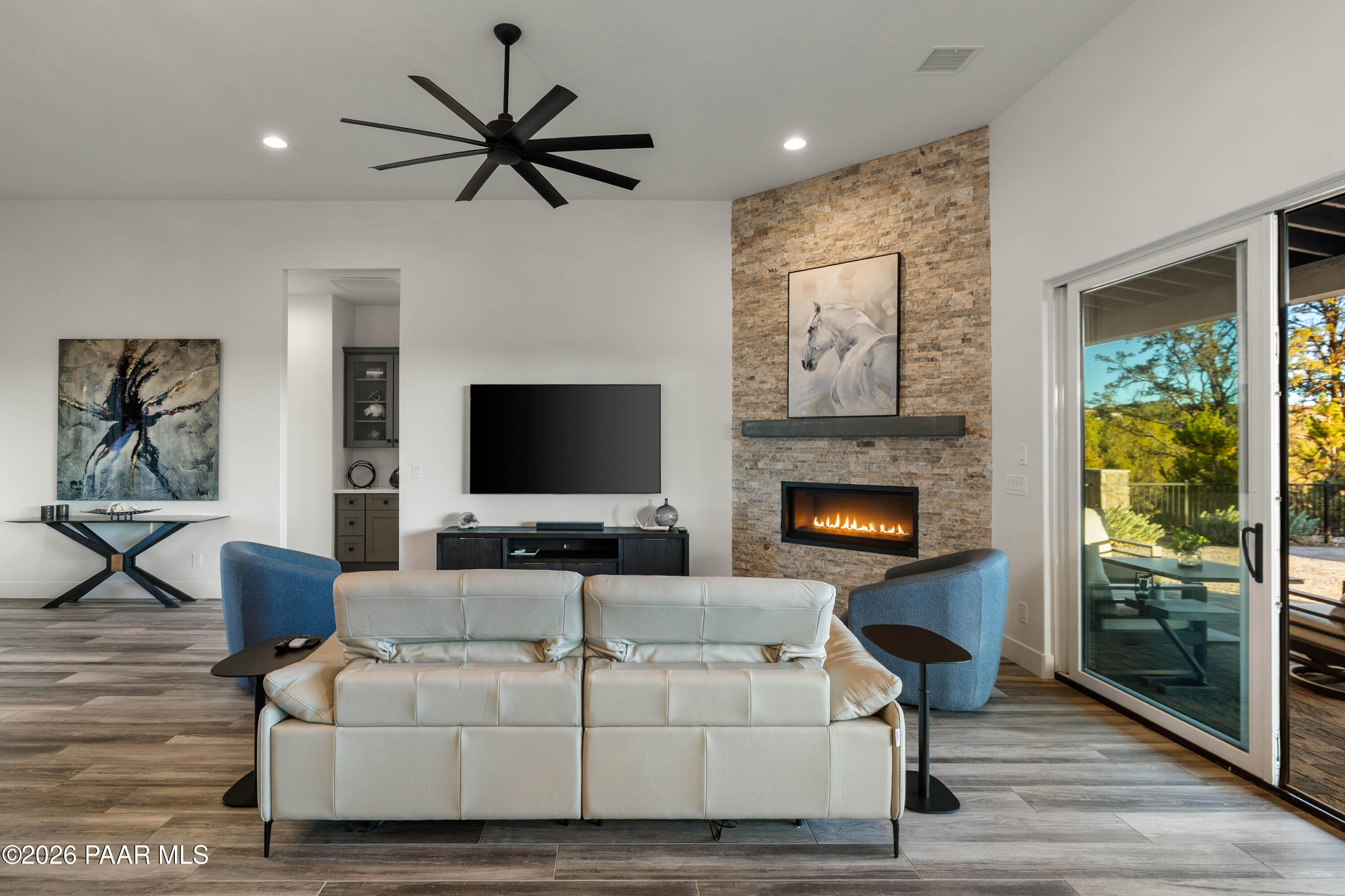 5475 West Three Forks Road Prescott, AZ 86305 - Photo 16 of 65 a living room with furniture a fireplace and a flat screen tv