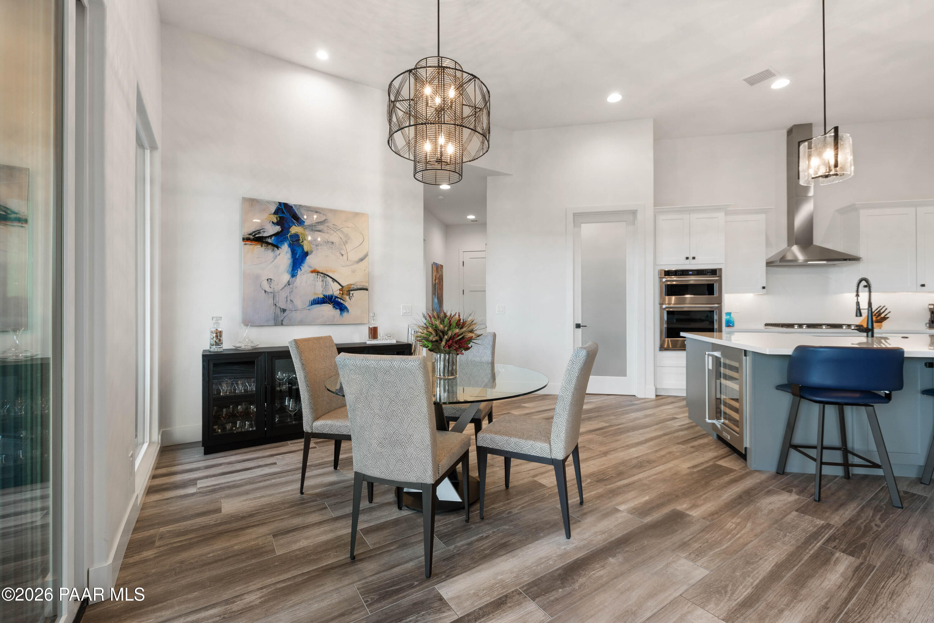 5475 West Three Forks Road Prescott, AZ 86305 - Photo 21 of 65 a view of a dining room with furniture wooden floor and chandelier