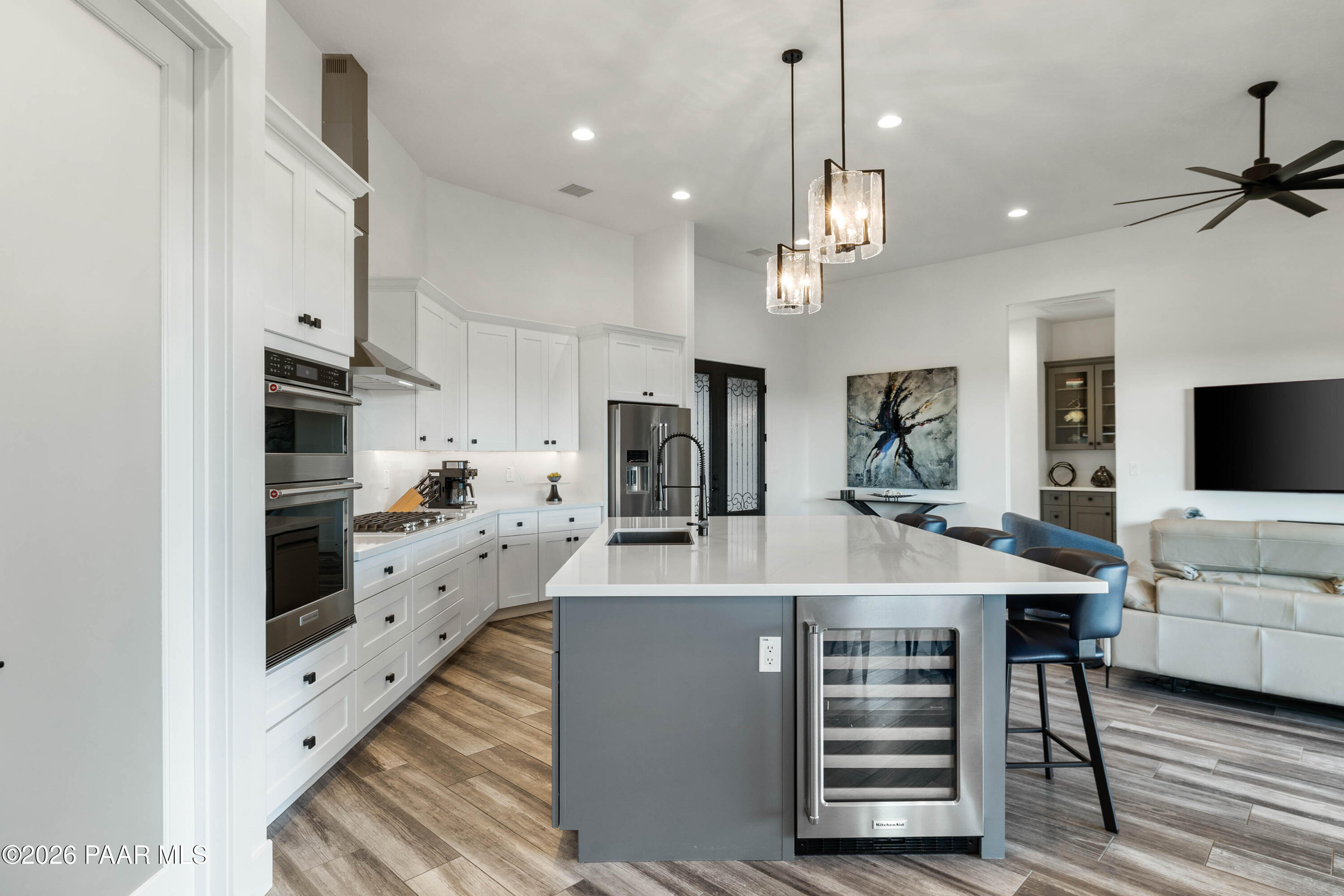 5475 West Three Forks Road Prescott, AZ 86305 - Photo 25 of 65 a large kitchen with stainless steel appliances kitchen island granite countertop a refrigerator and a stove top oven