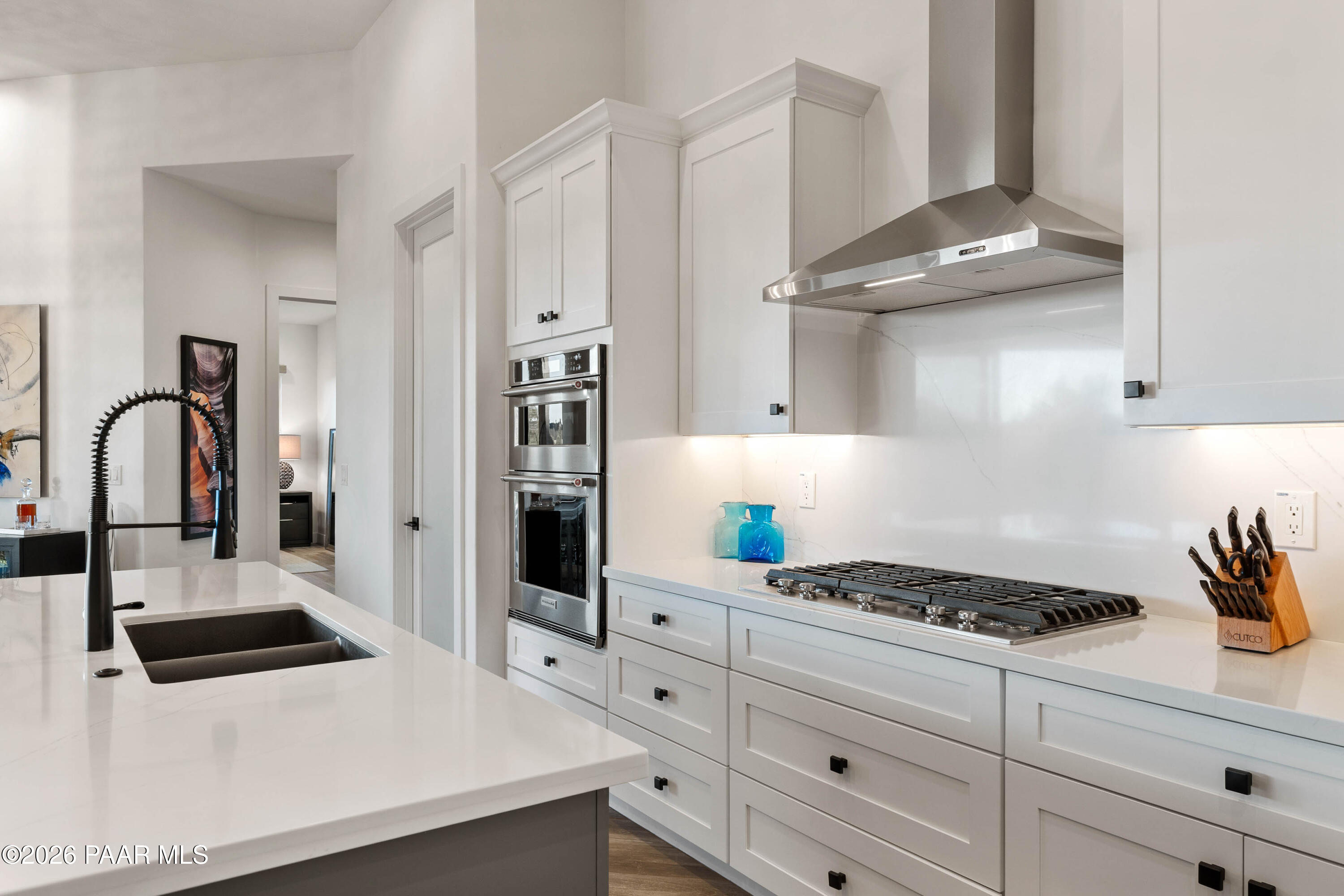 5475 West Three Forks Road Prescott, AZ 86305 - Photo 26 of 65 a kitchen with granite countertop a white stove and cabinets