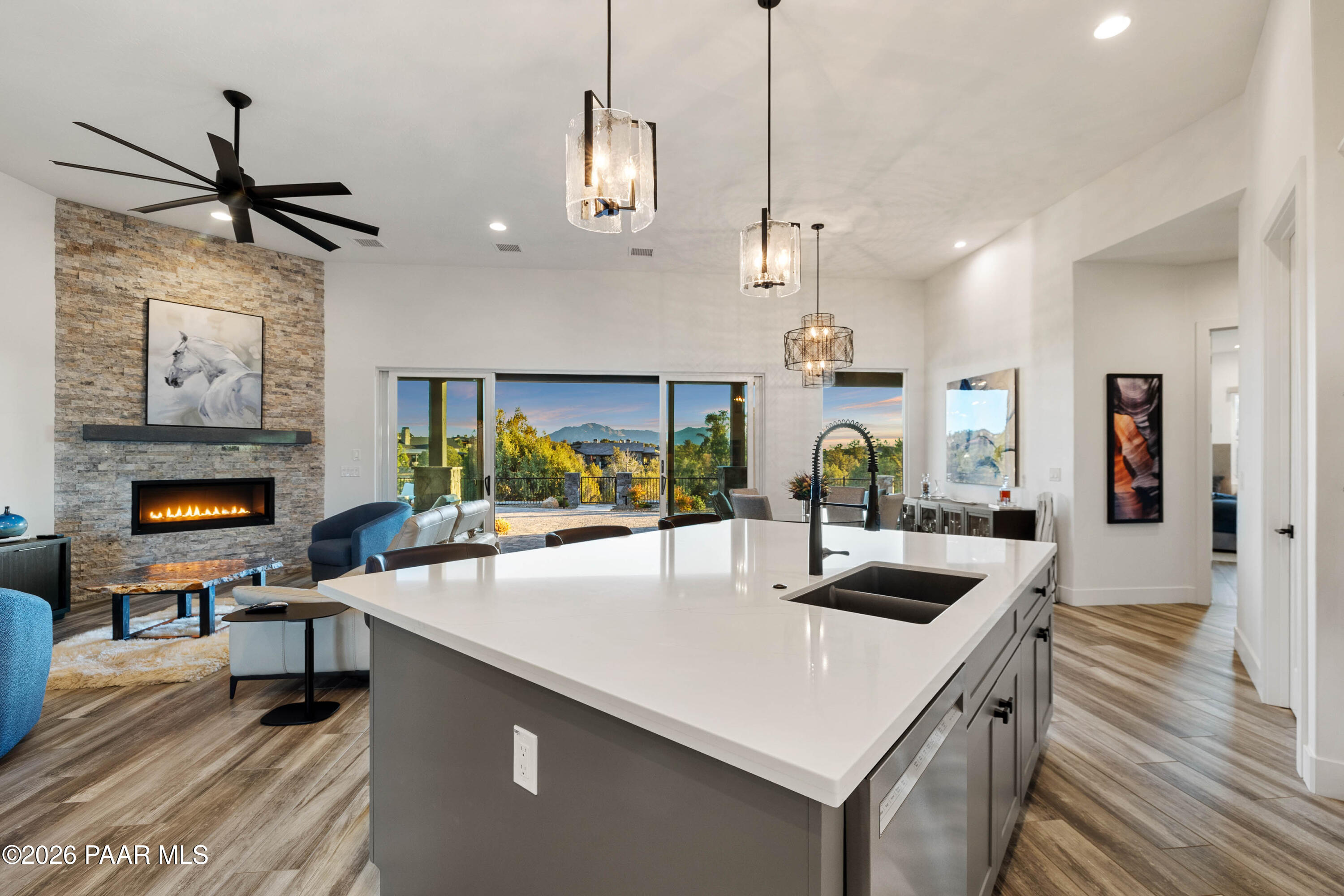 5475 West Three Forks Road Prescott, AZ 86305 - Photo 27 of 65 a kitchen with sink a stove and chairs with wooden floor