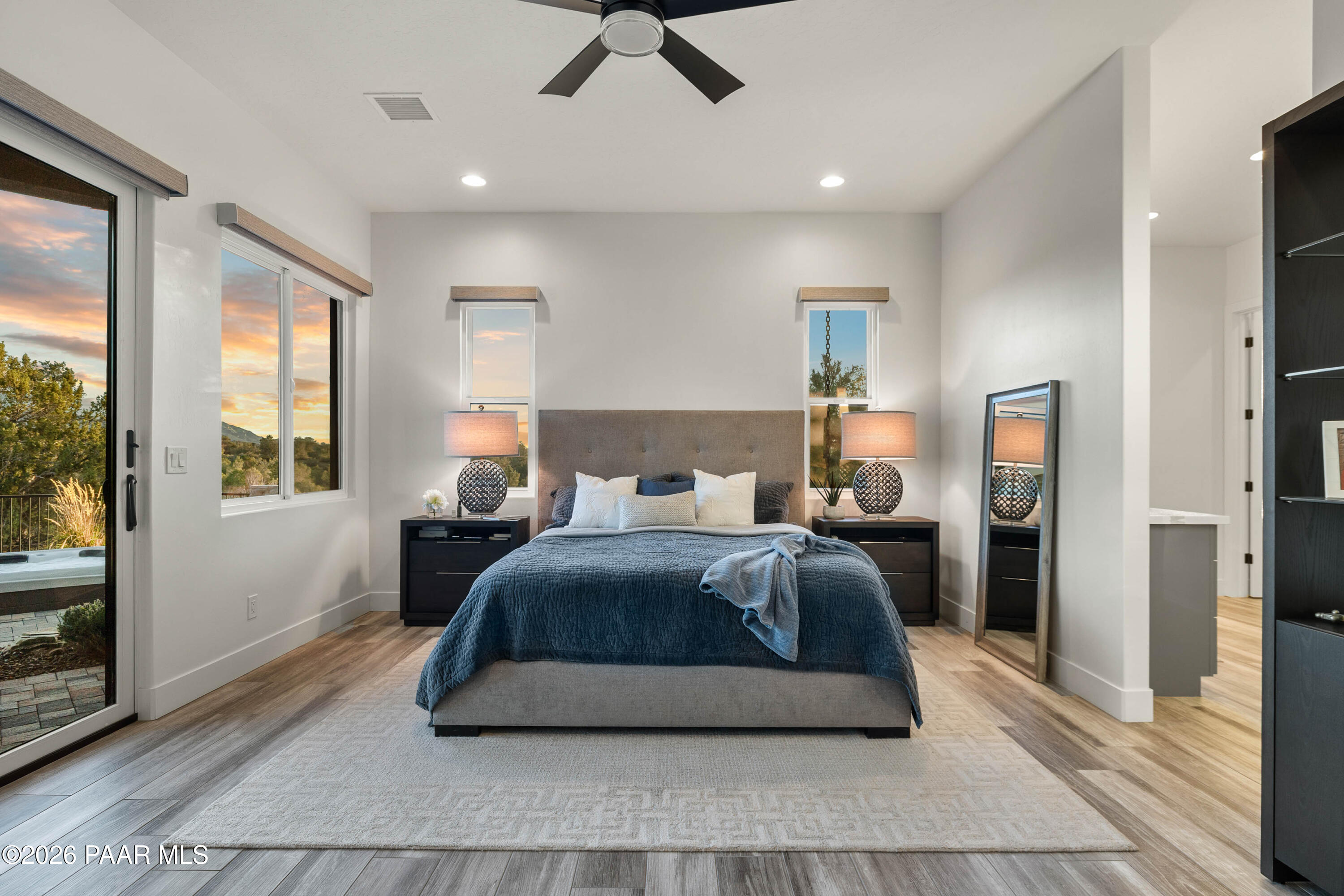 5475 West Three Forks Road Prescott, AZ 86305 - Photo 30 of 65 a bedroom with a bed lamp and a large window