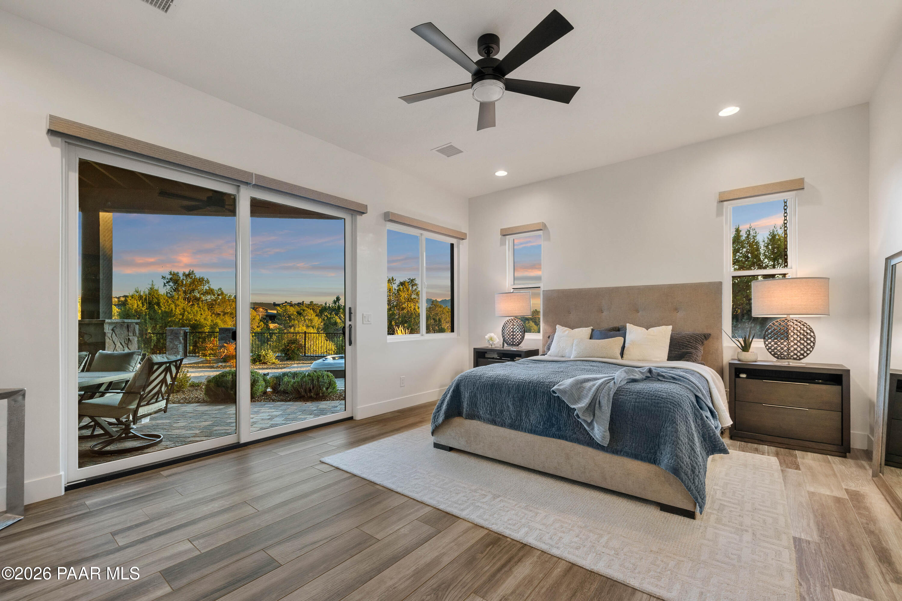 5475 West Three Forks Road Prescott, AZ 86305 - Photo 31 of 65 a bedroom with a large bed and a chandelier