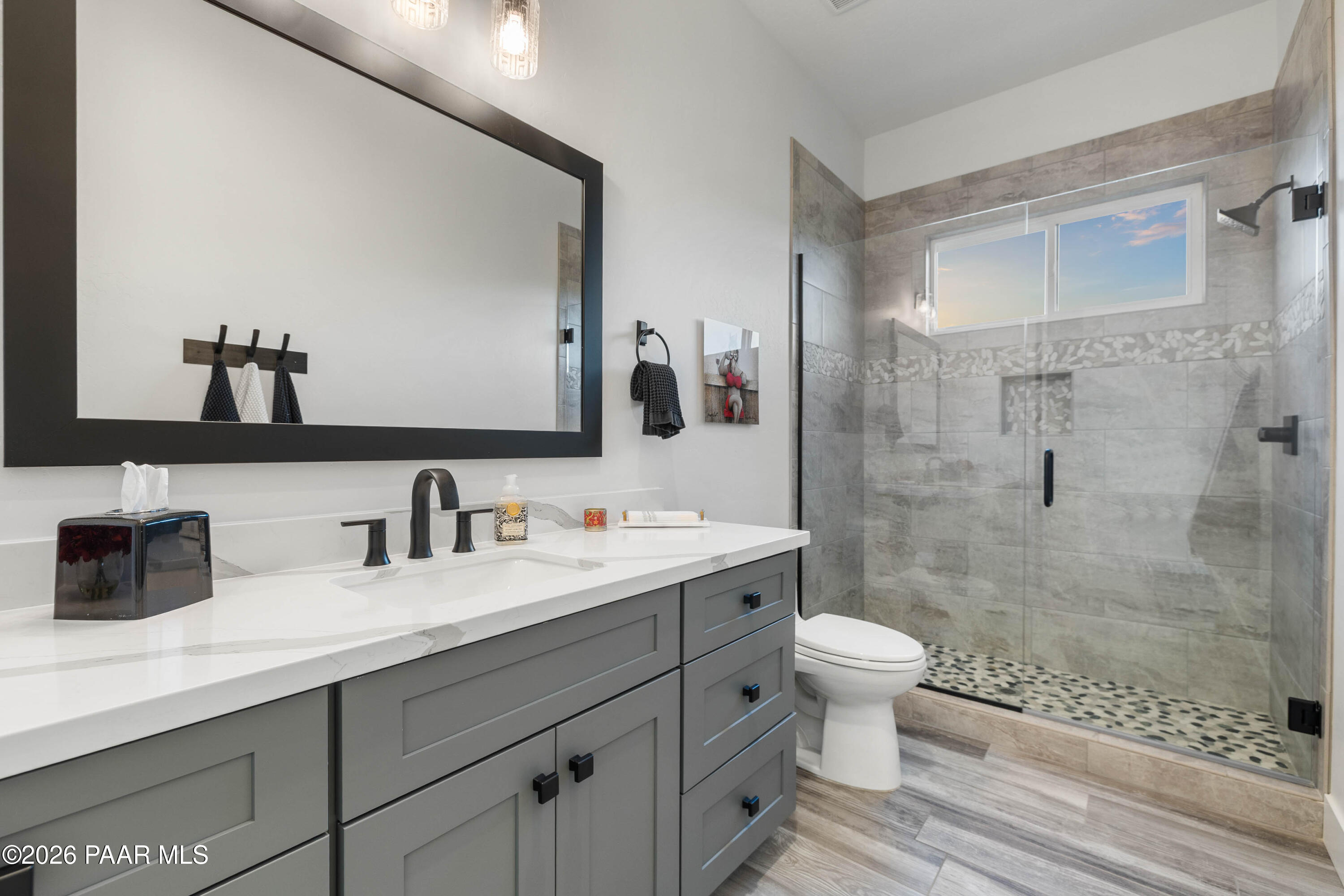 5475 West Three Forks Road Prescott, AZ 86305 - Photo 47 of 65 a bathroom with a double vanity sink toilet and shower