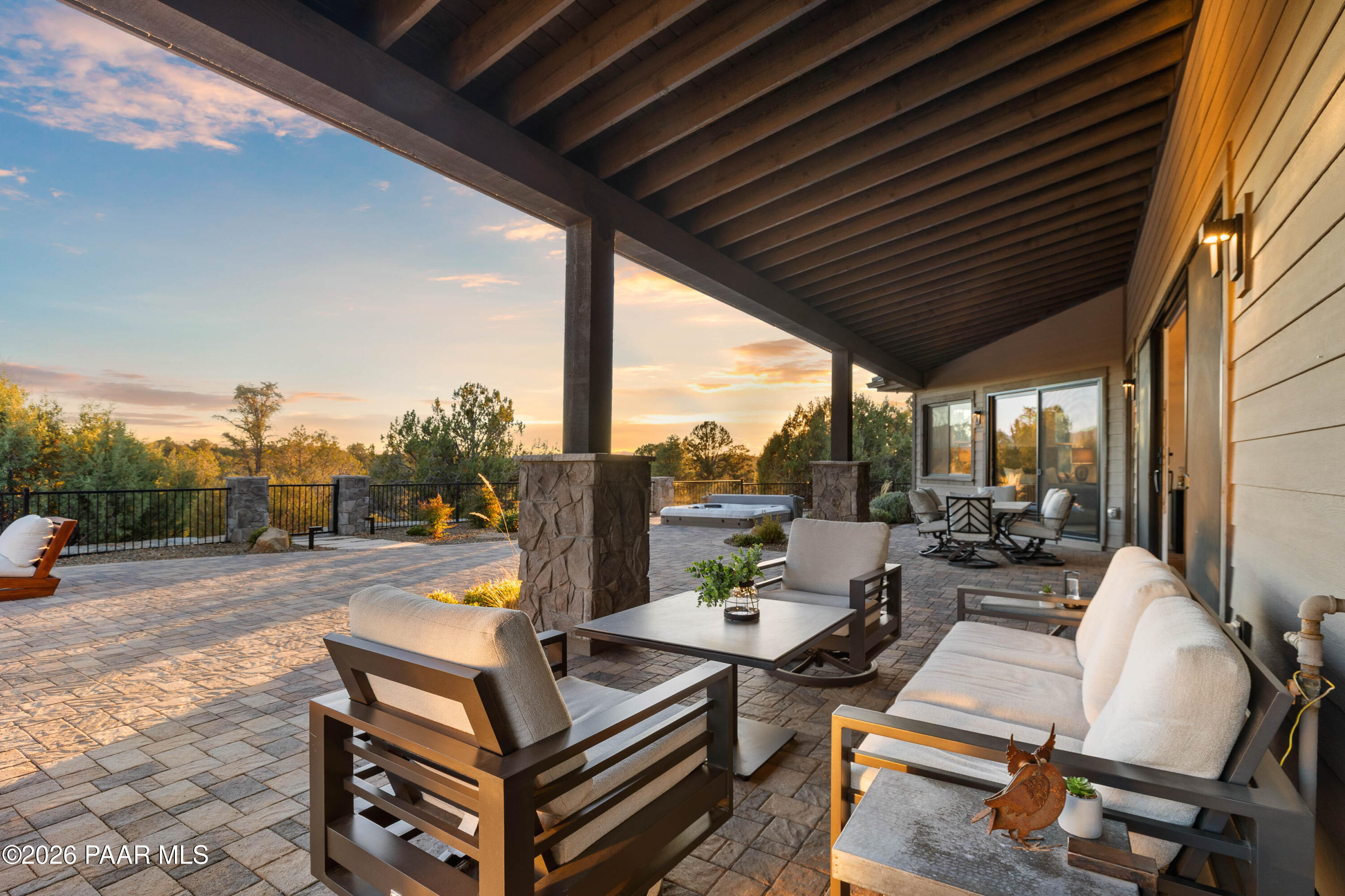 5475 West Three Forks Road Prescott, AZ 86305 - Photo 58 of 65 a view of a patio with a dining table and chairs with a small yard