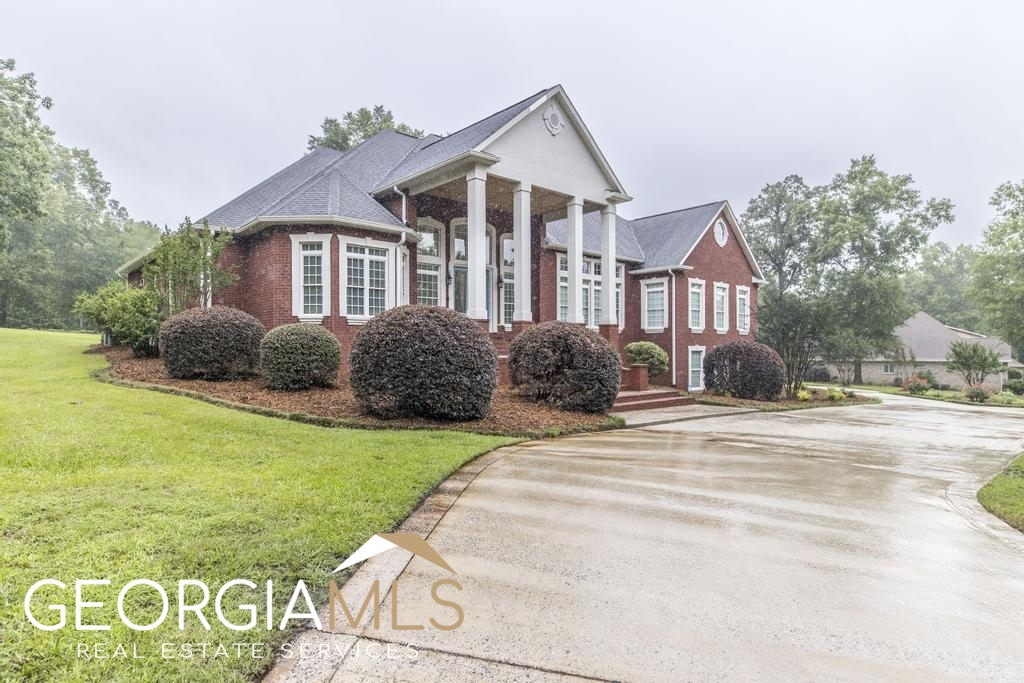 144 Keith Road Bonaire, GA 31005 - Photo 1 of 1 a front view of a house with garden