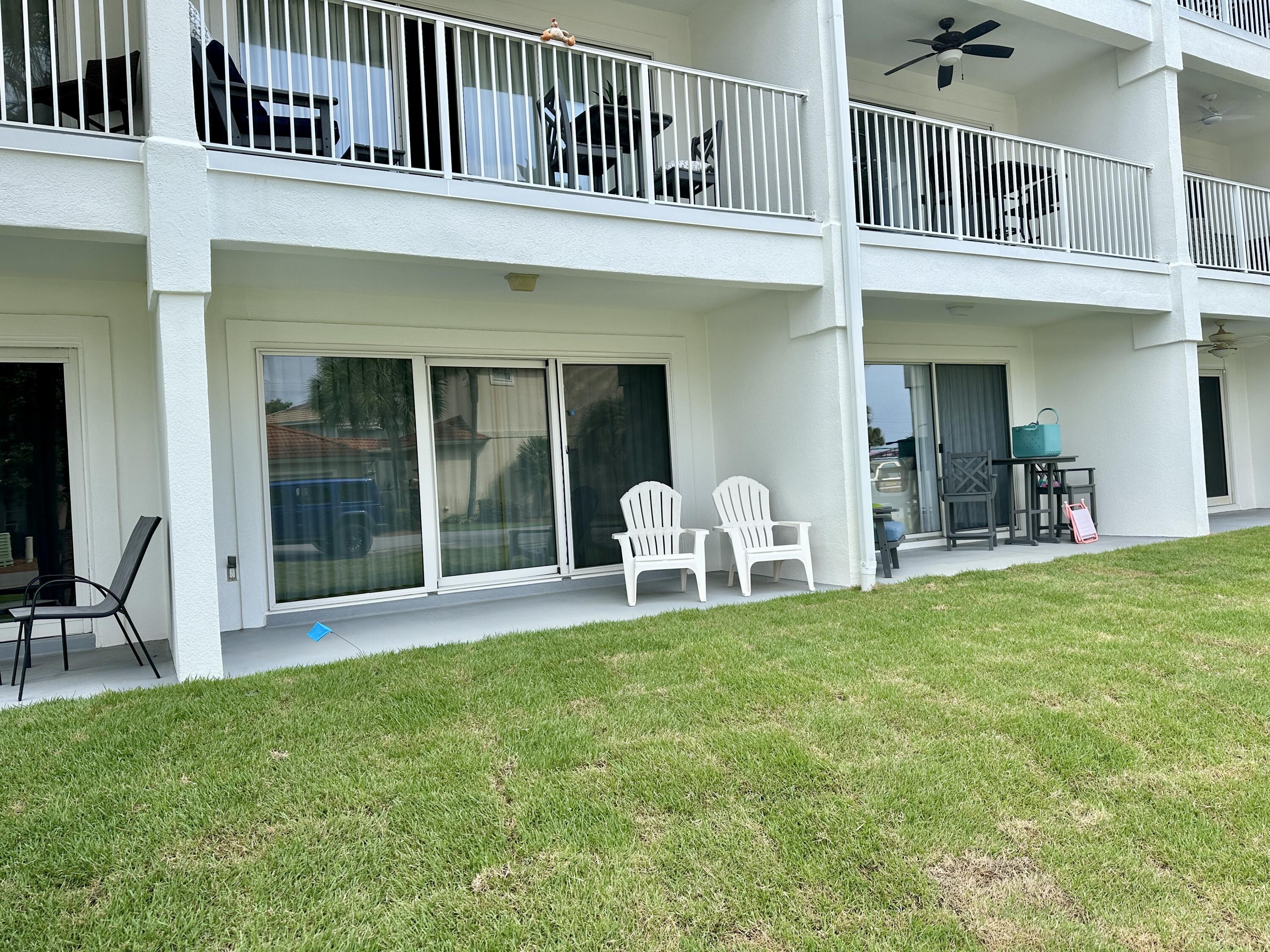 2606 Scenic Gulf Drive, Unit 4107 Miramar Beach, FL 32550 - Photo 19 of 55 a view of a house with pool and a yard