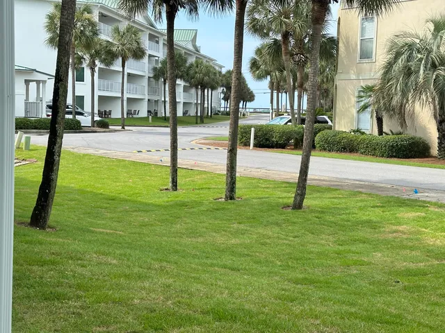 a view of a balcony with dining table and chairs