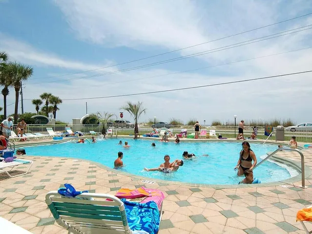 a view of a swimming pool with outdoor seating