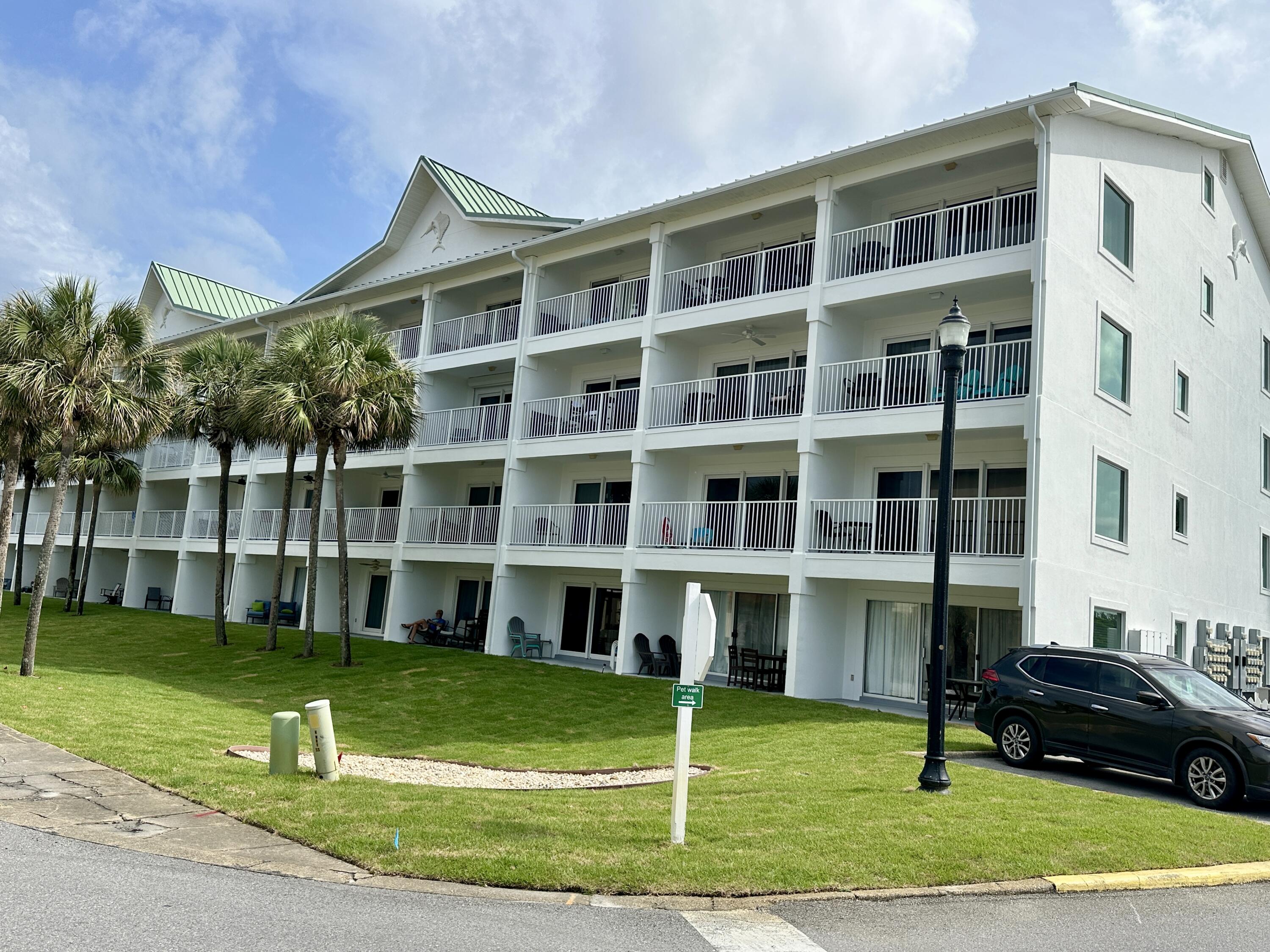 2606 Scenic Gulf Drive, Unit 4107 Miramar Beach, FL 32550 - Photo 43 of 55 a front view of a building with a yard