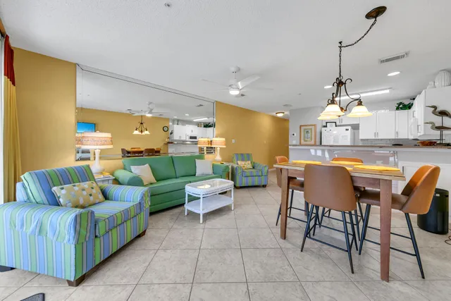 a living room with lots of furniture and a chandelier