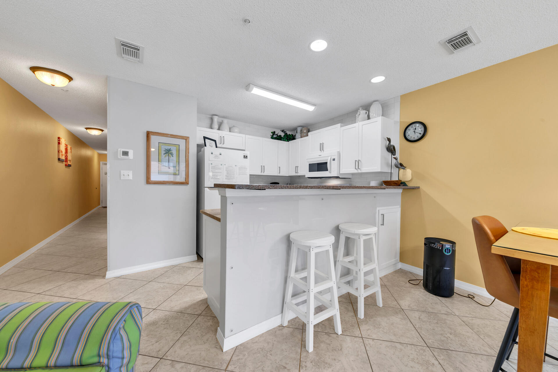 2606 Scenic Gulf Drive, Unit 4107 Miramar Beach, FL 32550 - Photo 10 of 55 a kitchen with stainless steel appliances granite countertop a sink and a refrigerator
