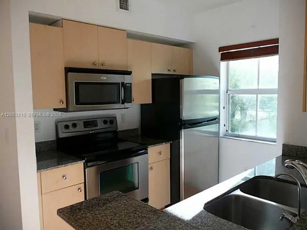 a kitchen with a refrigerator stove and microwave