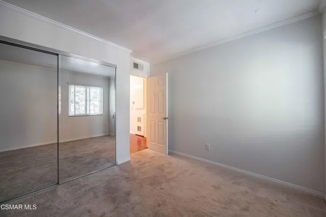a bathroom with a granite countertop double vanity sink and mirror