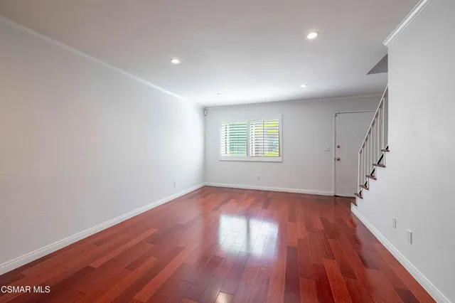 a large kitchen with stainless steel appliances granite countertop a refrigerator and a sink