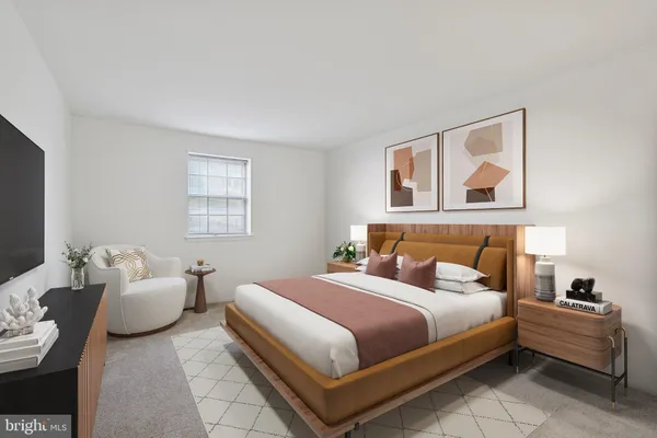 a bedroom with a bed and a couch