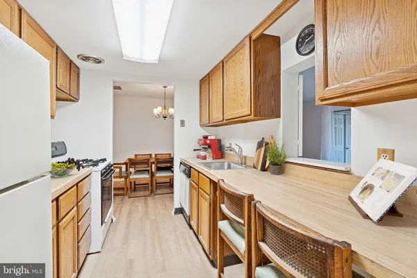 a open kitchen with stainless steel appliances granite countertop a stove and a wooden floors