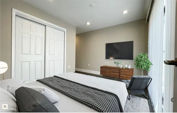 a bedroom with a bed and a flat screen tv