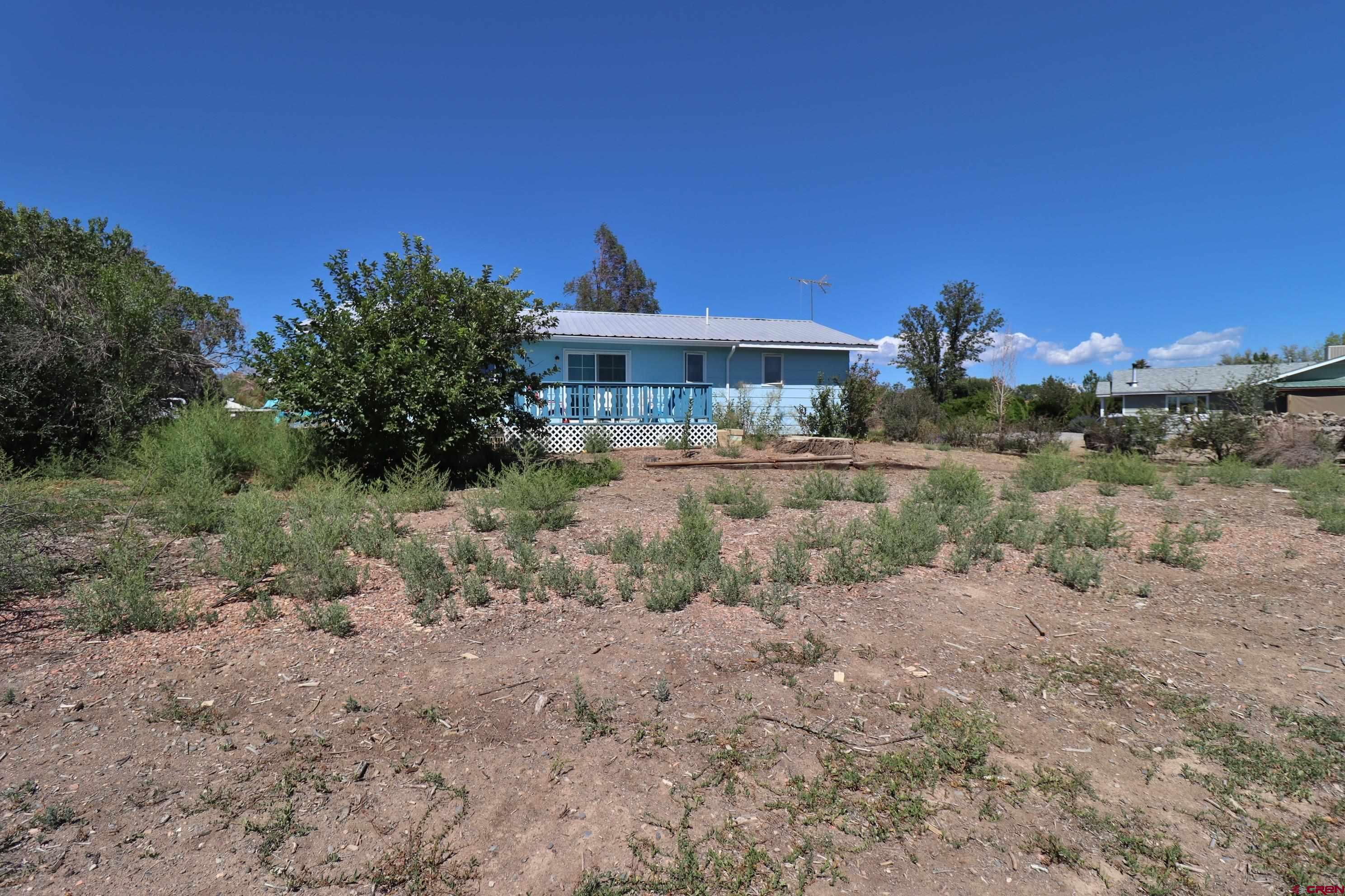 12303 West Spring Circle Eckert, CO 81418 - Photo 18 of 26 a view of a house with a yard