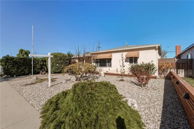 a view of a backyard house and floor to ceiling window