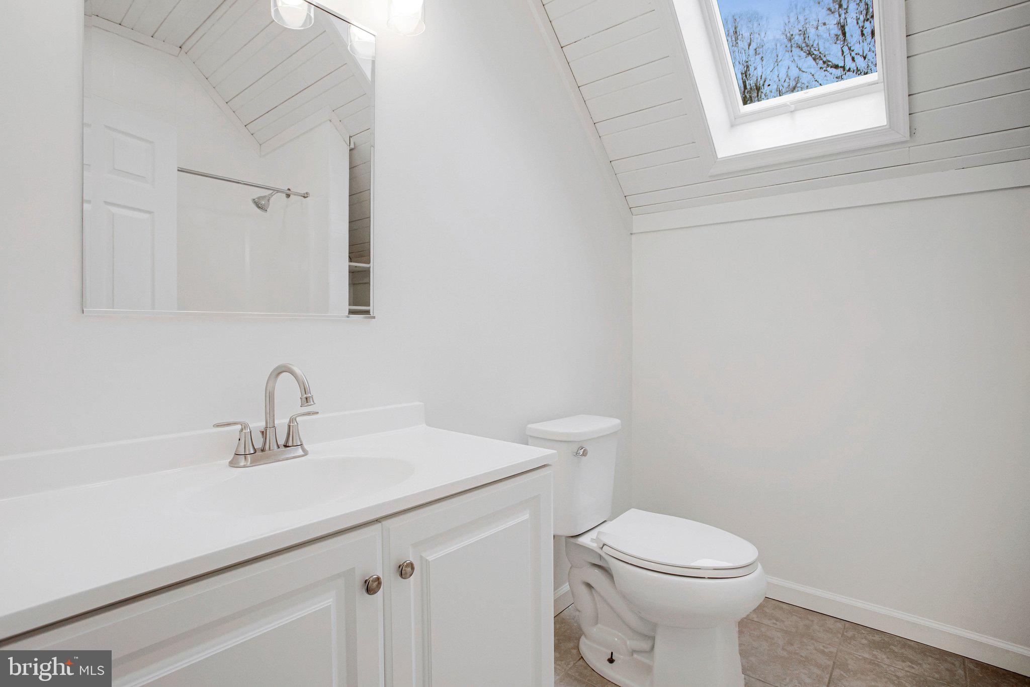 4350 Camp Kaufmann Road Huntingtown, MD 20639 - Photo 12 of 23 a bathroom with a sink a toilet and mirror