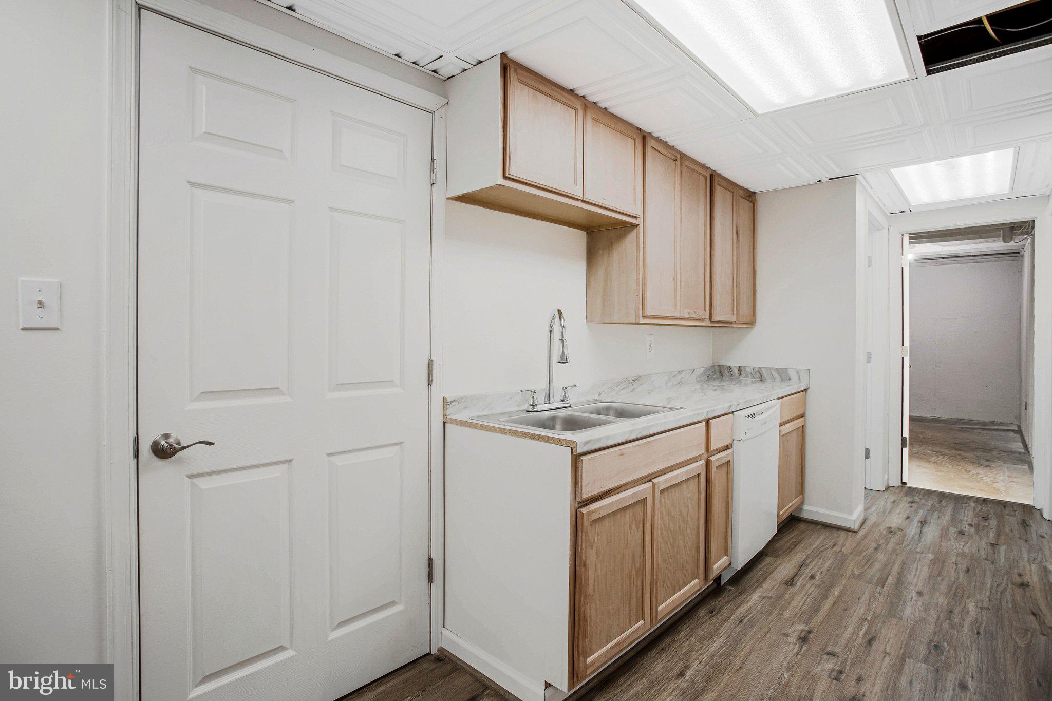 4350 Camp Kaufmann Road Huntingtown, MD 20639 - Photo 14 of 23 a kitchen with a sink cabinets stainless steel appliances and a window