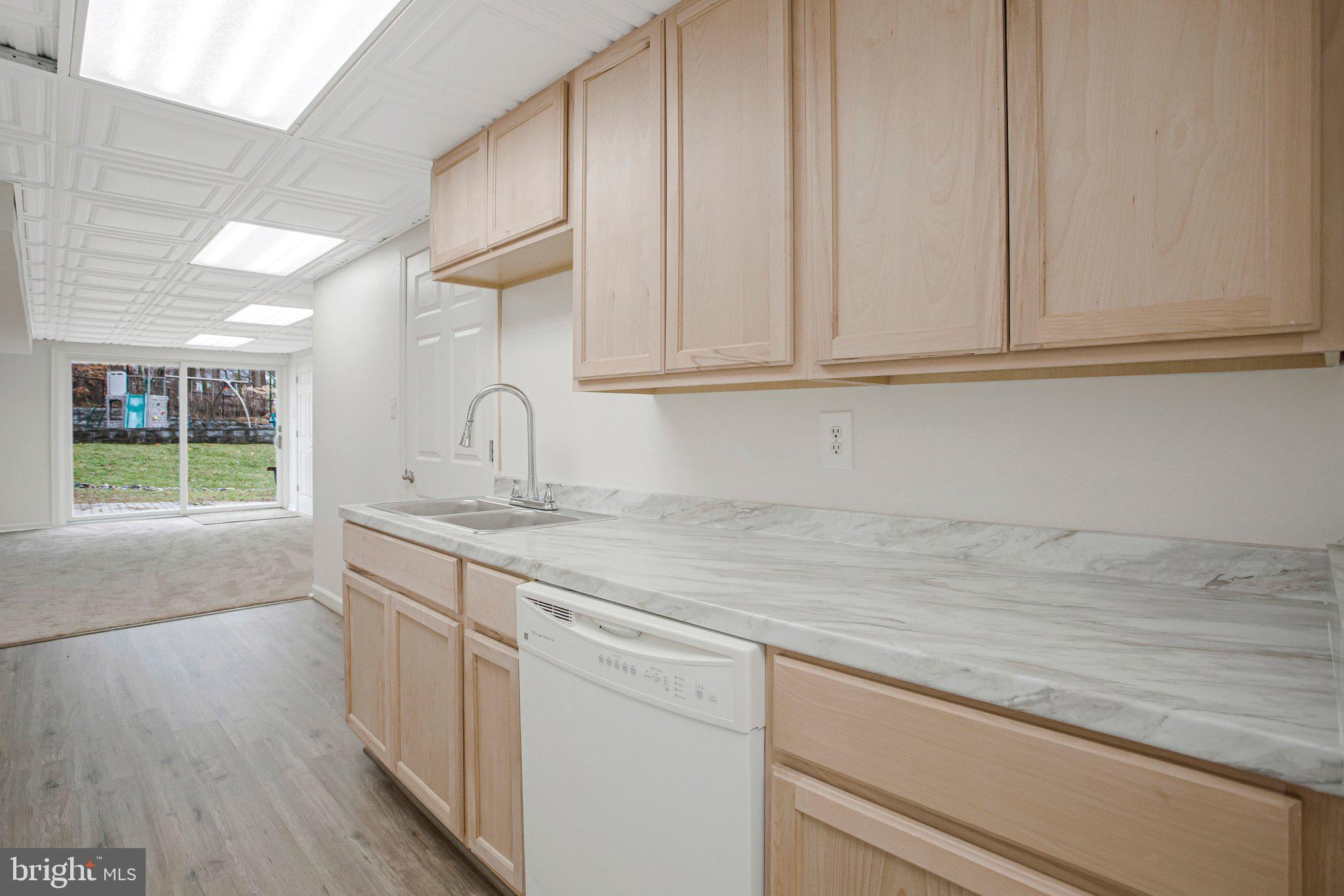 4350 Camp Kaufmann Road Huntingtown, MD 20639 - Photo 15 of 23 a kitchen with stainless steel appliances granite countertop a sink and dishwasher with wooden floor