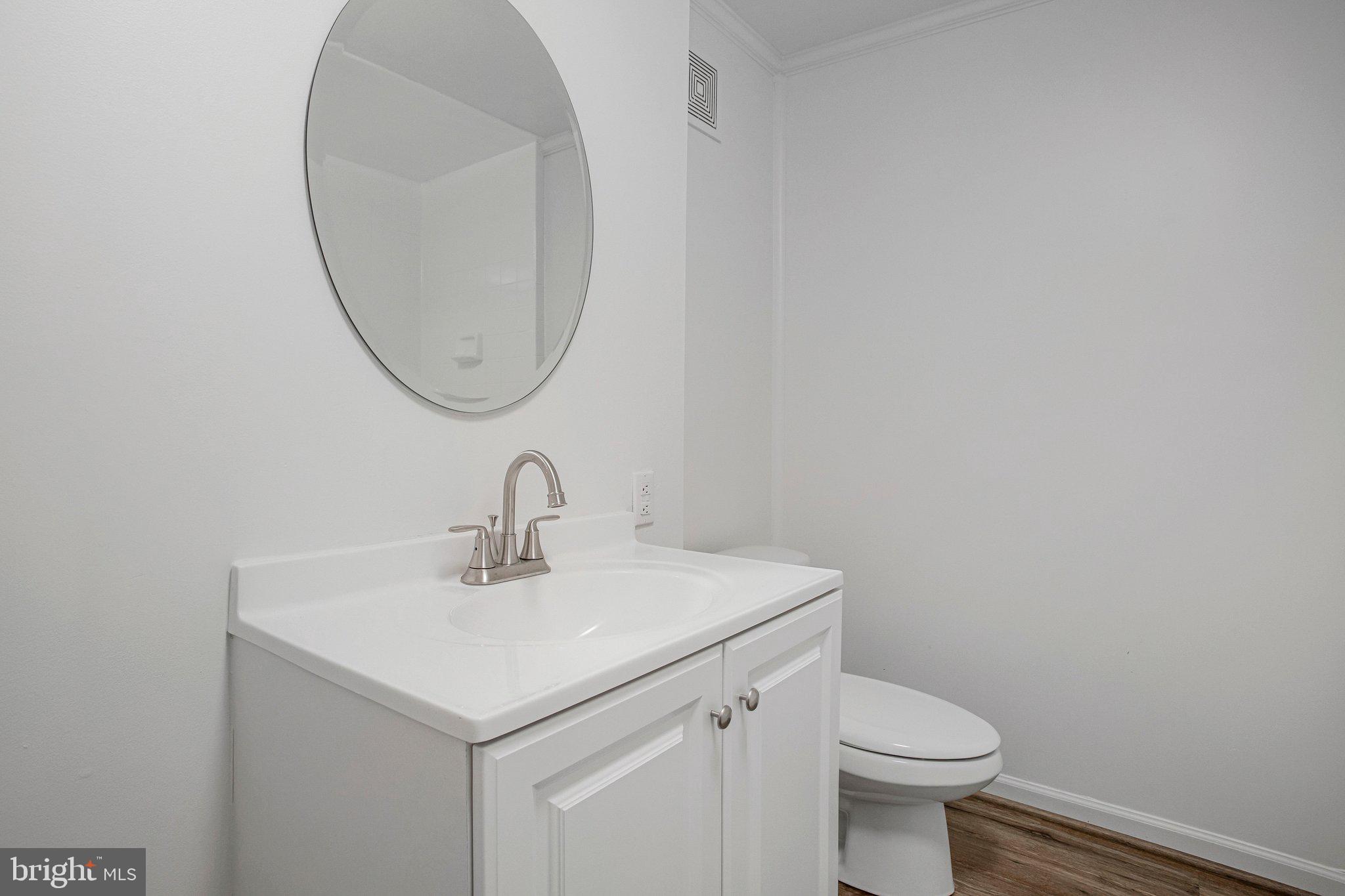 4350 Camp Kaufmann Road Huntingtown, MD 20639 - Photo 16 of 23 a bathroom with a sink a toilet and a mirror