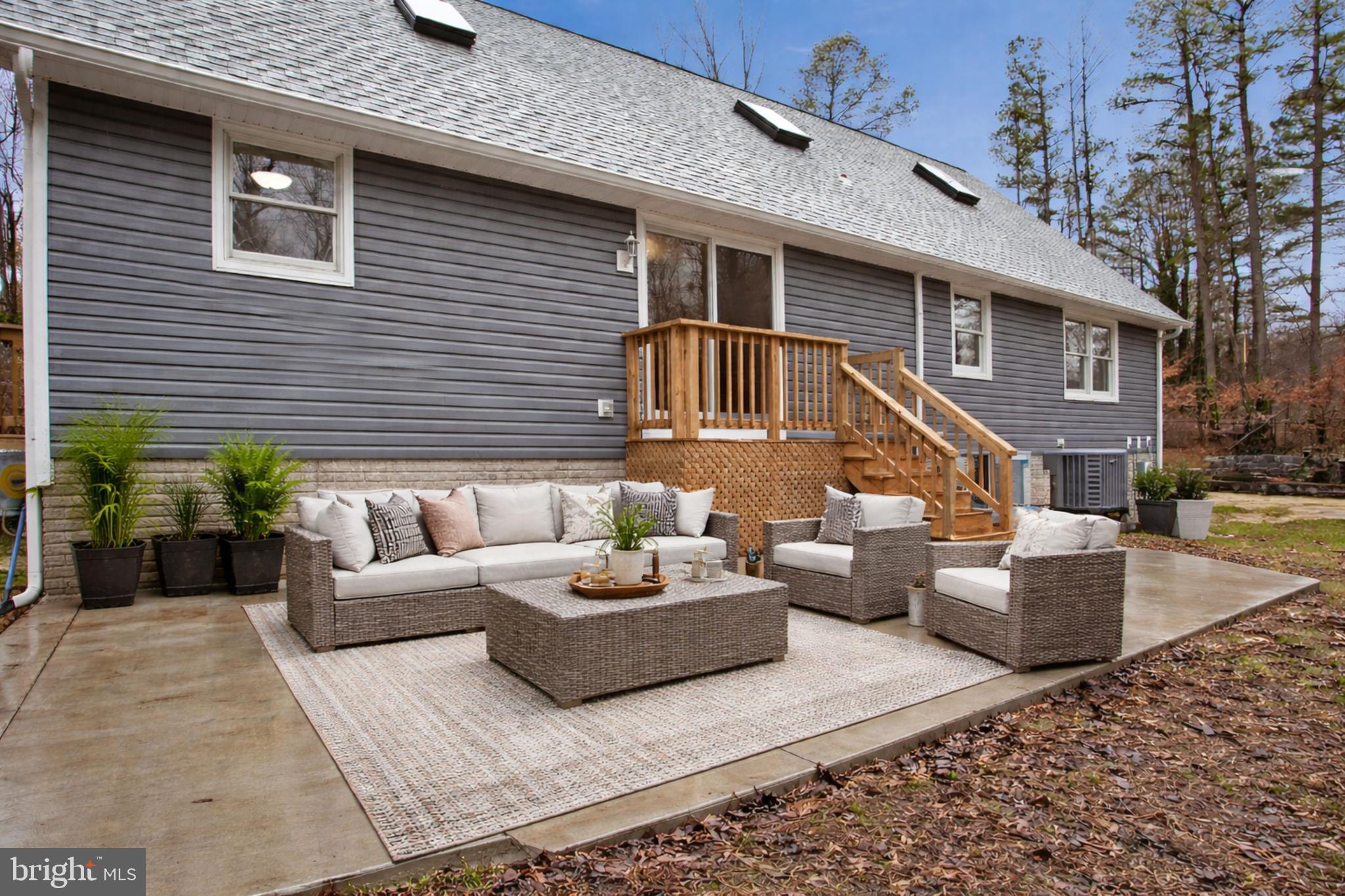 4350 Camp Kaufmann Road Huntingtown, MD 20639 - Photo 18 of 23 a view of a patio with couches table and chairs with wooden floor and fence