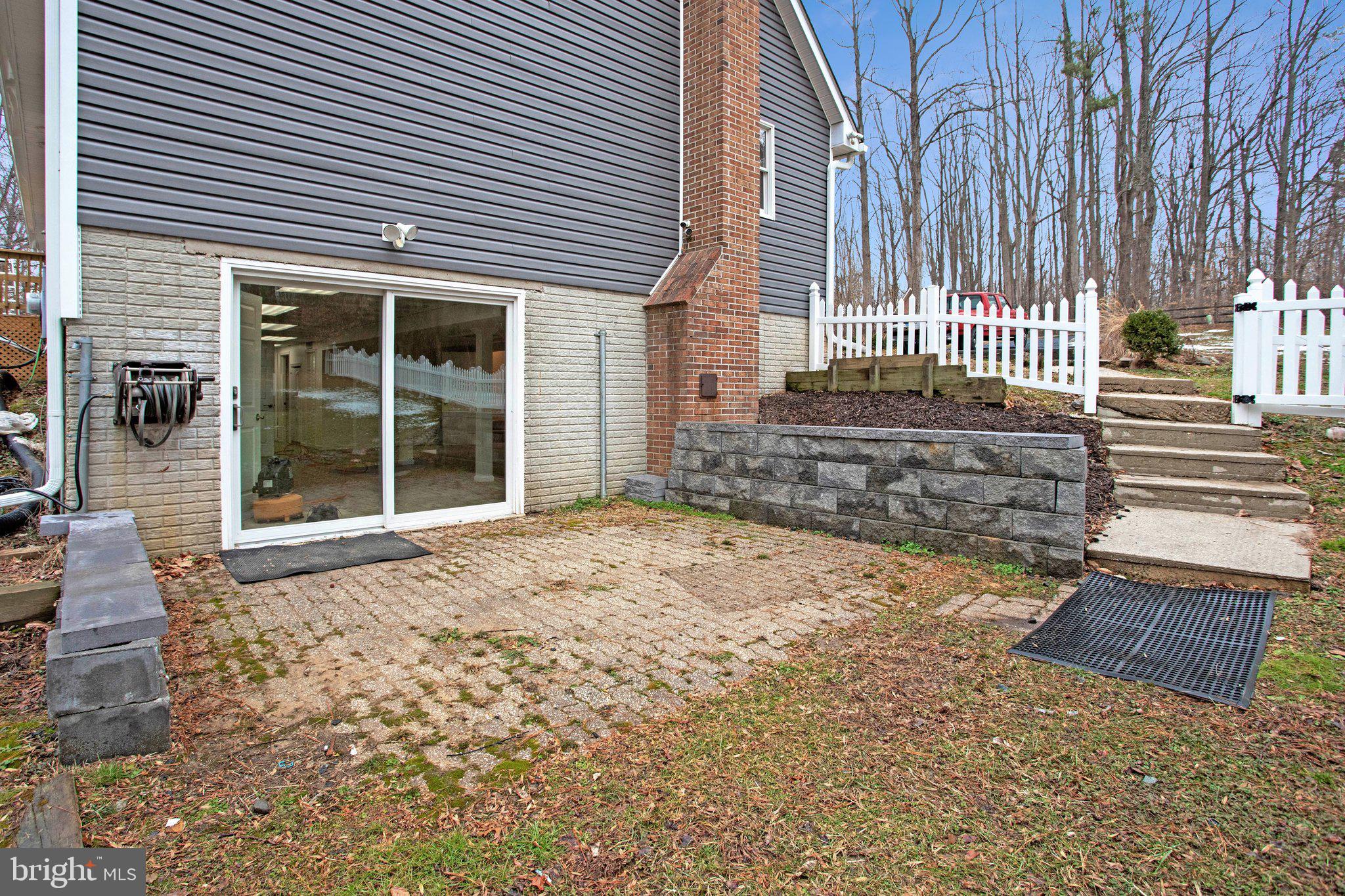 4350 Camp Kaufmann Road Huntingtown, MD 20639 - Photo 20 of 23 a front view of a house with a garden