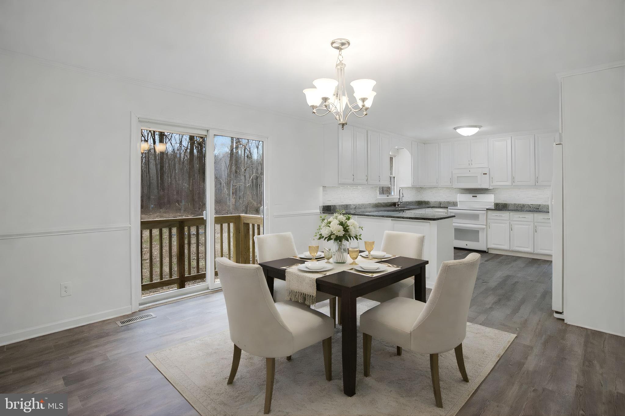 4350 Camp Kaufmann Road Huntingtown, MD 20639 - Photo 3 of 23 a view of a dining room with furniture a chandelier and wooden floor