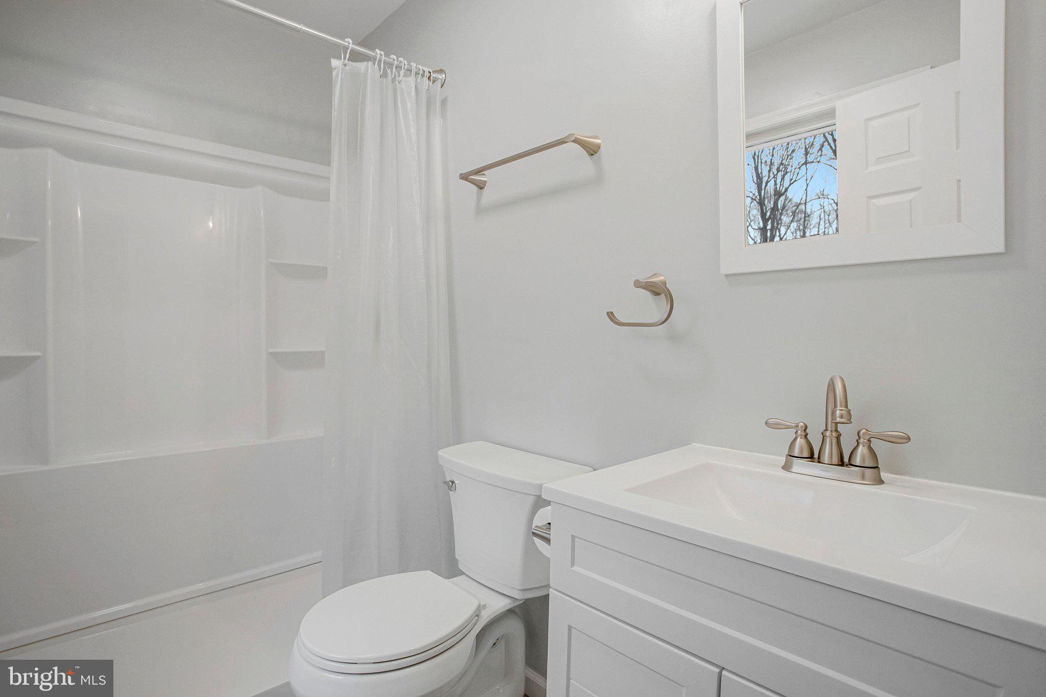 4350 Camp Kaufmann Road Huntingtown, MD 20639 - Photo 6 of 23 a bathroom with a sink a toilet and shower